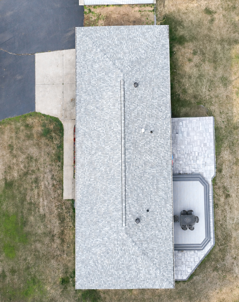 Overhead view of a long ranch roof showing straight shingle courses and clean rake edges