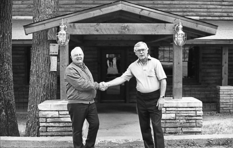 Zibolski and Hecimovich family members shaking hands outside a Tomahawk area lodge
