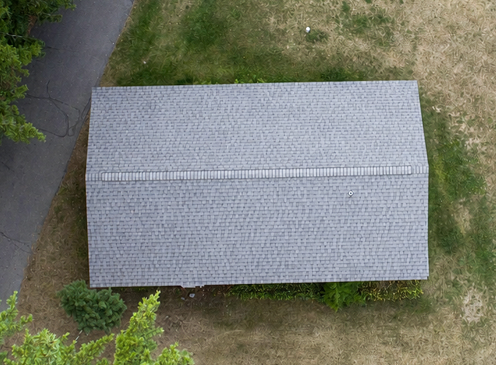 Aerial view of a detached garage with a new shingle roof and ridge vent