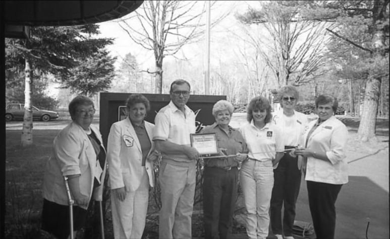 Tomahawk chamber ribbon cutting with the Zibolski and Hecimovich families outside their Northwoods property