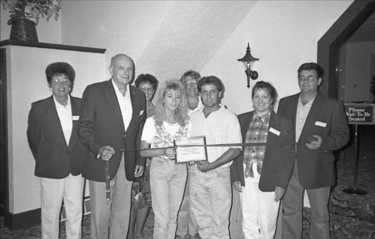Ribbon cutting ceremony inside a Tomahawk area hospitality business with the Zibolski and Hecimovich families